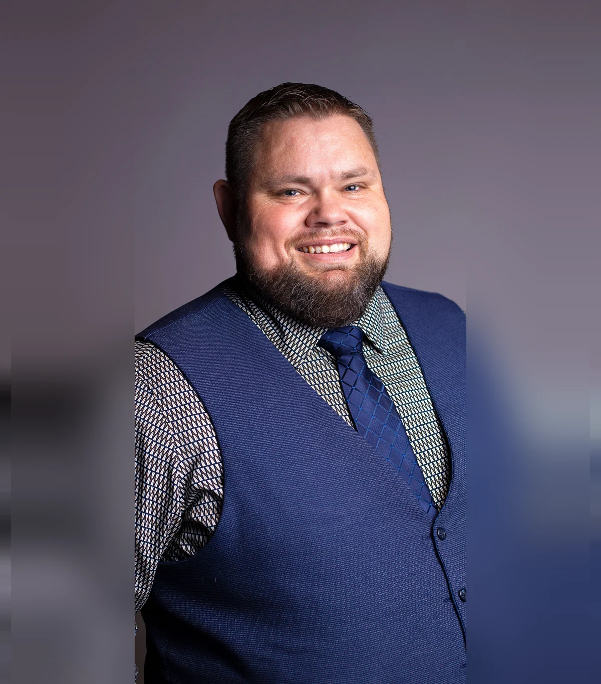 Studio portrait of Mark Christiansen, owner of Best DJ Idaho, in a vest and tie