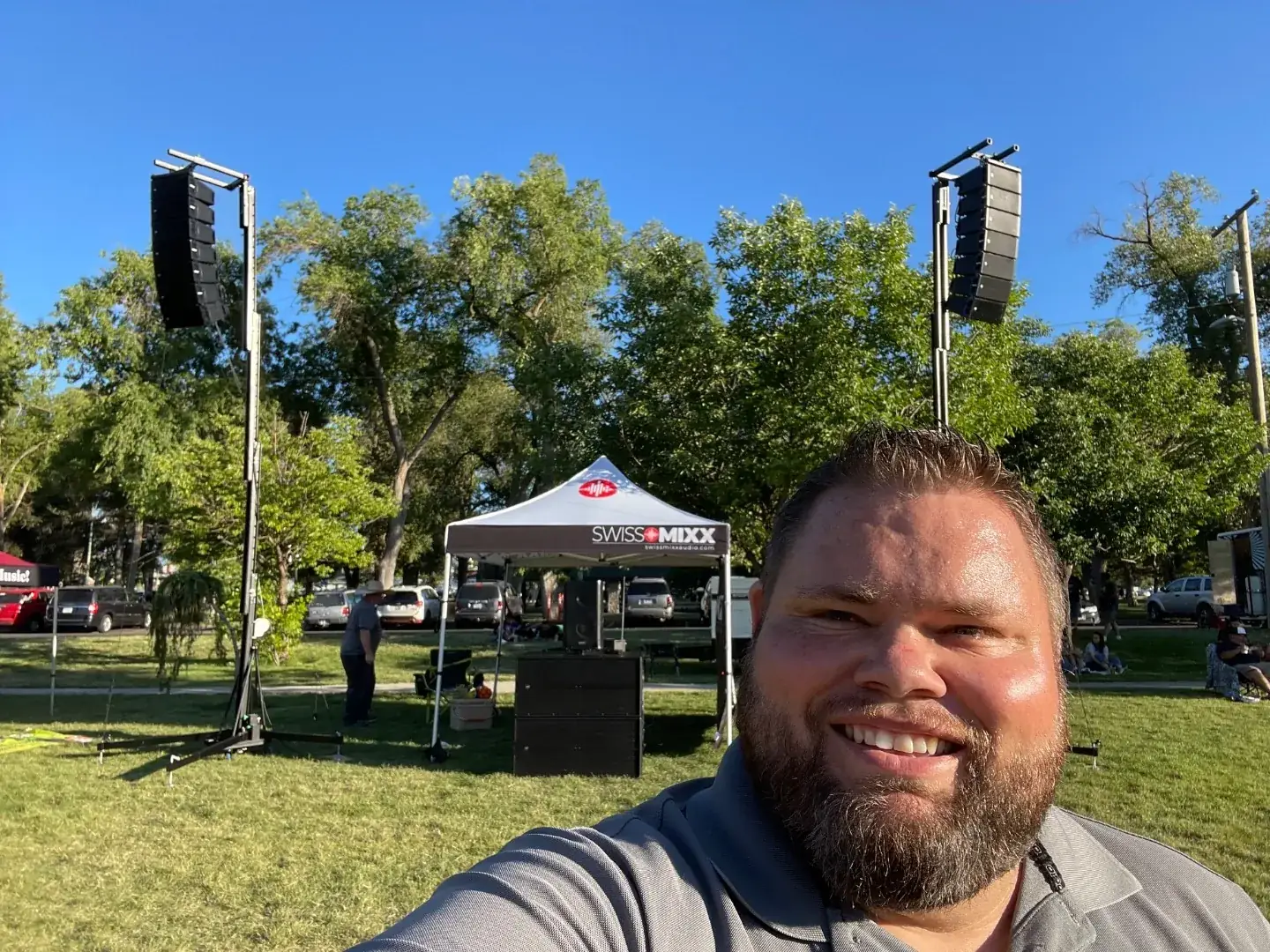 Mark Christiansen with line array speakers at an outdoor stage