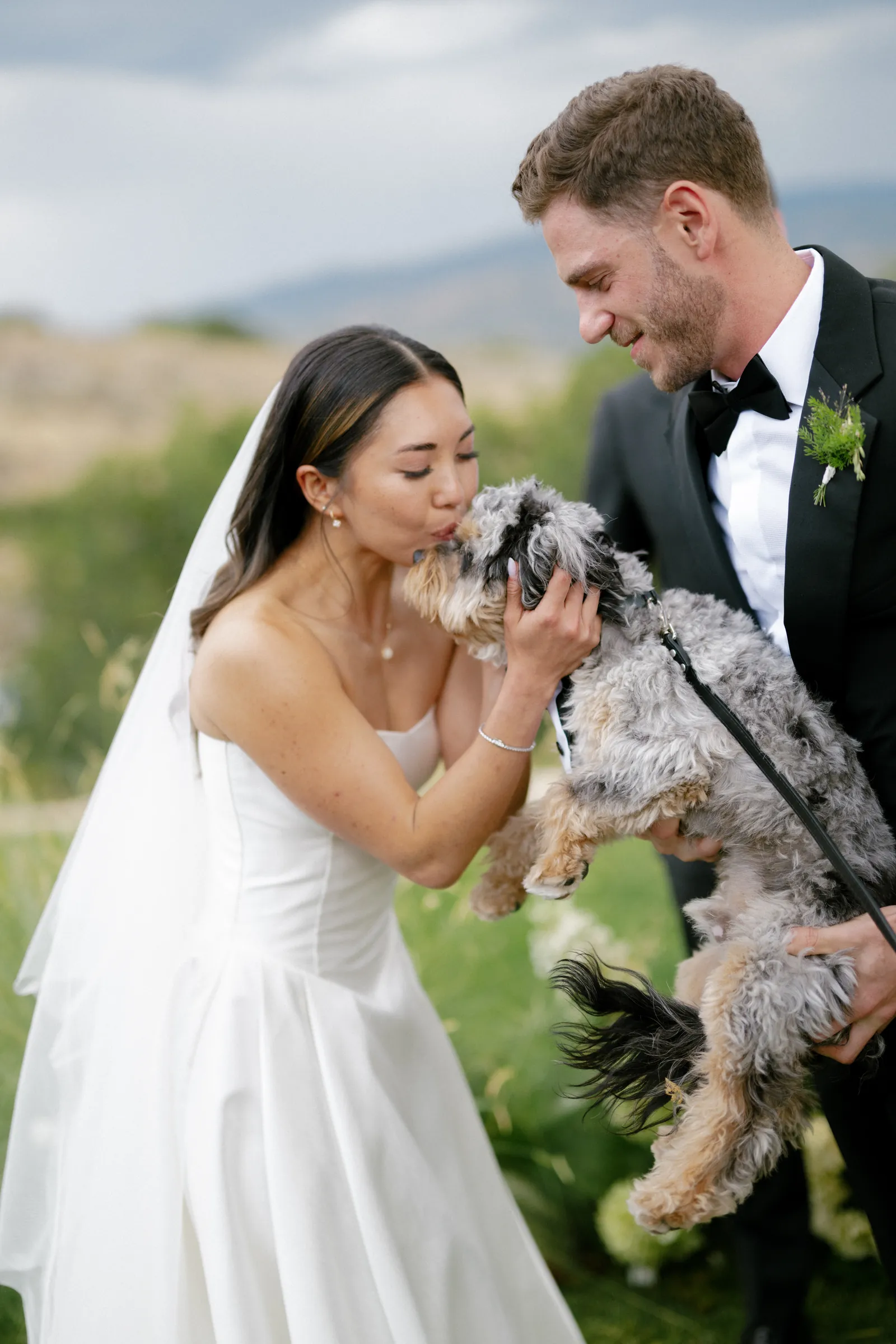 Bride kissing her dog after the ceremony