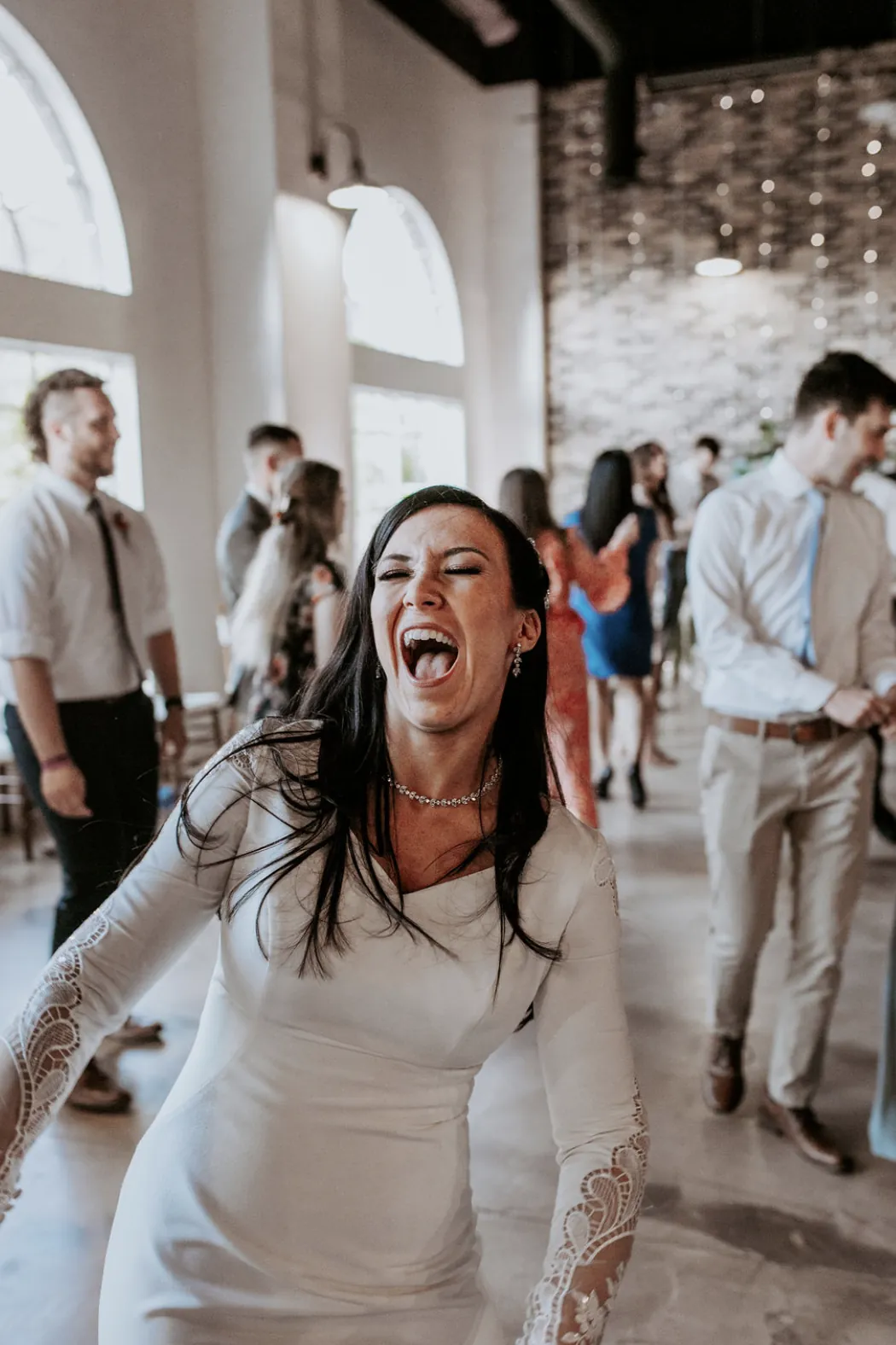 Bride laughing mid-dance at her reception