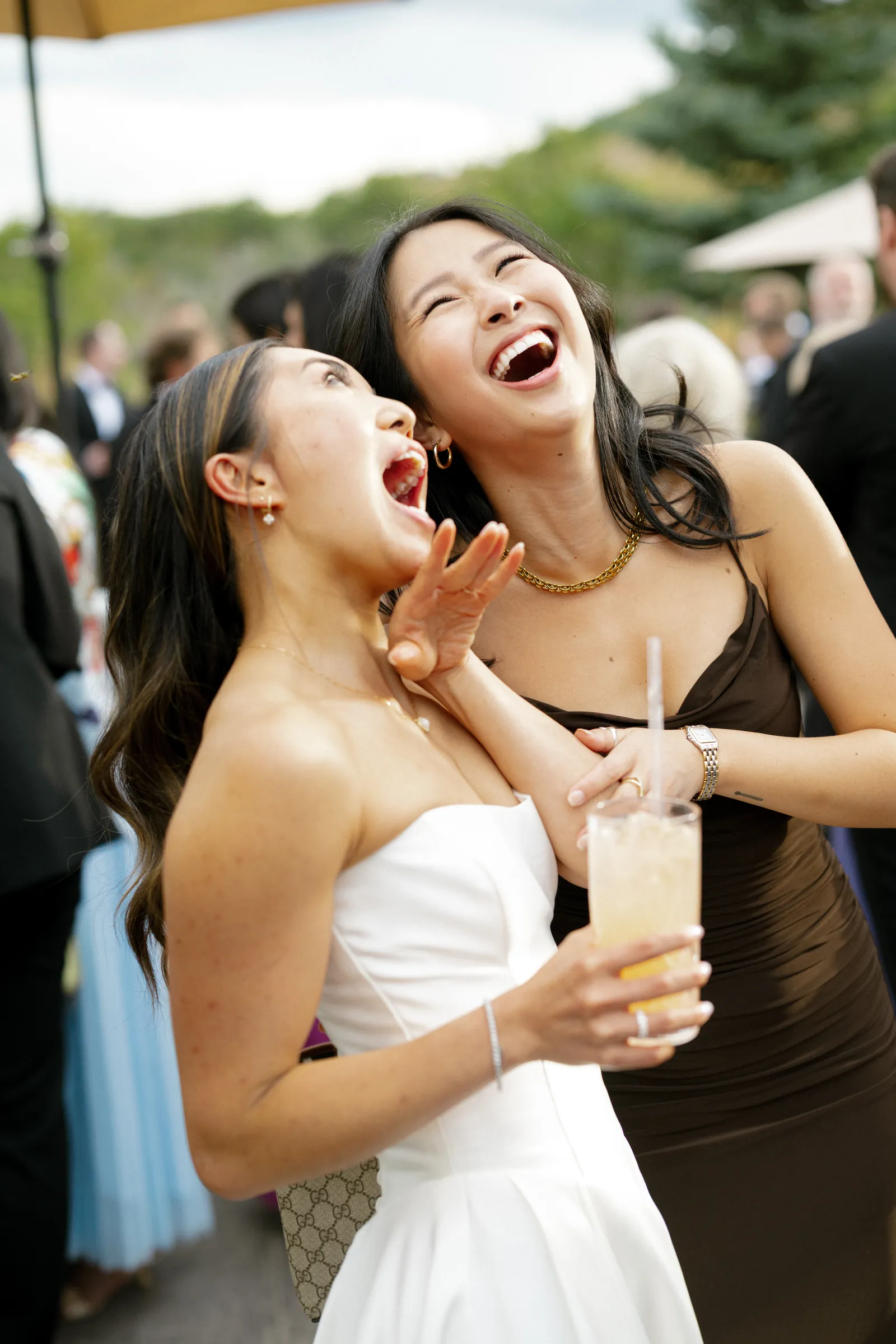 Bride laughing with a friend during cocktail hour