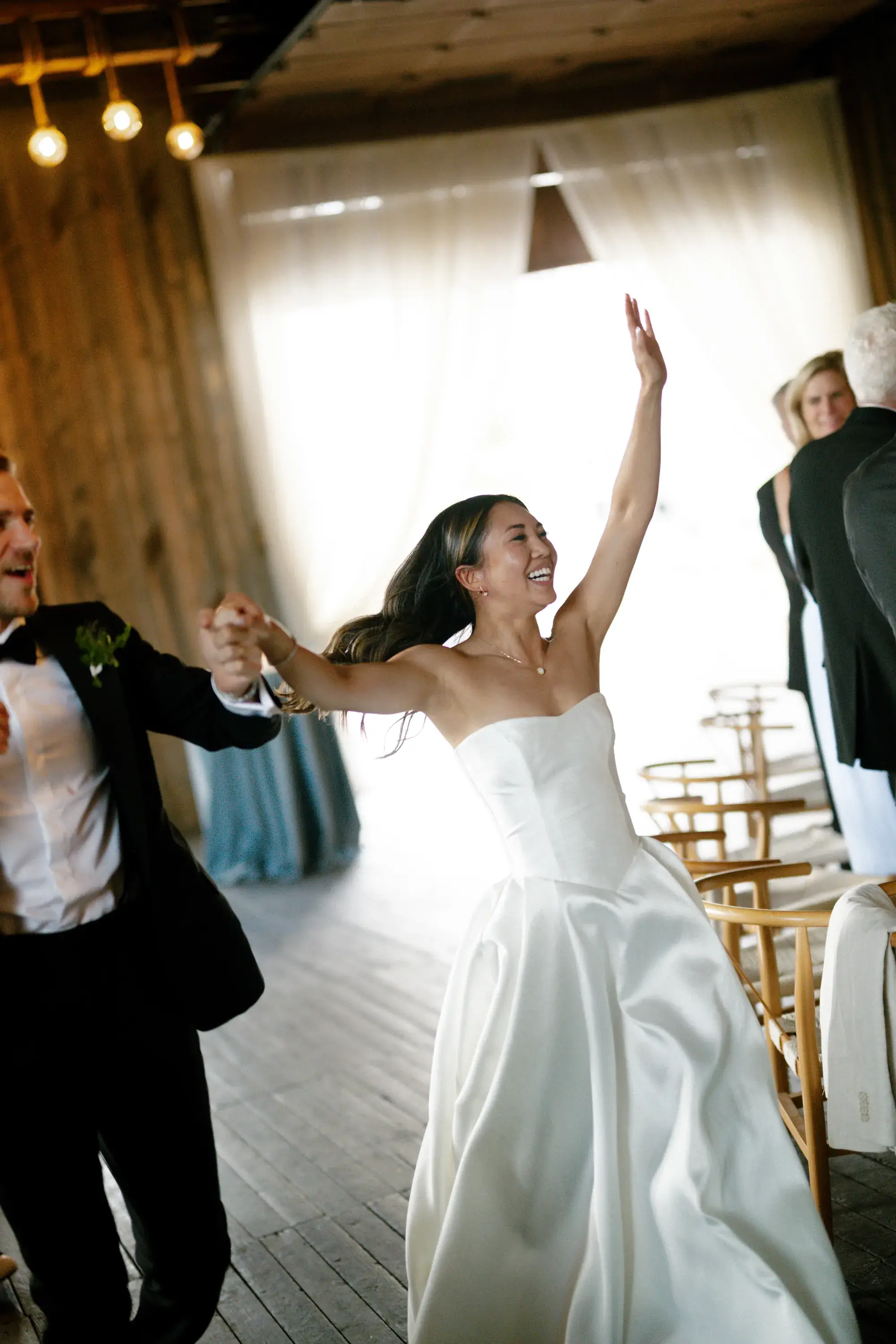 Couple dancing beneath ivory ceiling drapes